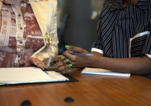 The hands of two colleagues in a meeting at work